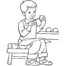 Boy painting eggs while sitting on a bench coloring page