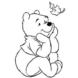 Winnie the Pooh watching a falling leaf coloring page